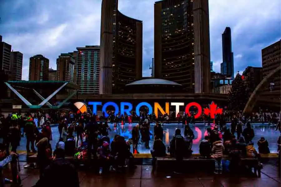 People Gathered in Front of Toronto Freestanding Signage
